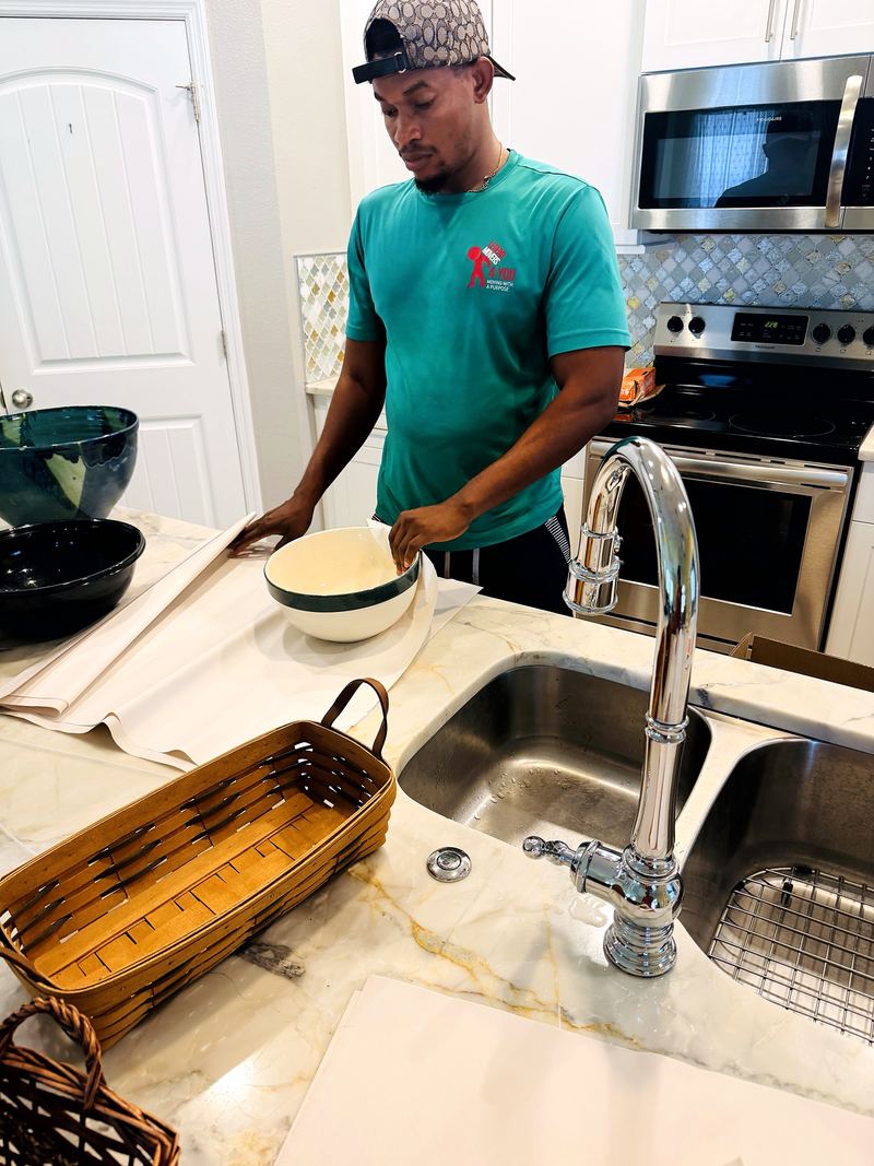Mover packing kitchen items at the counter