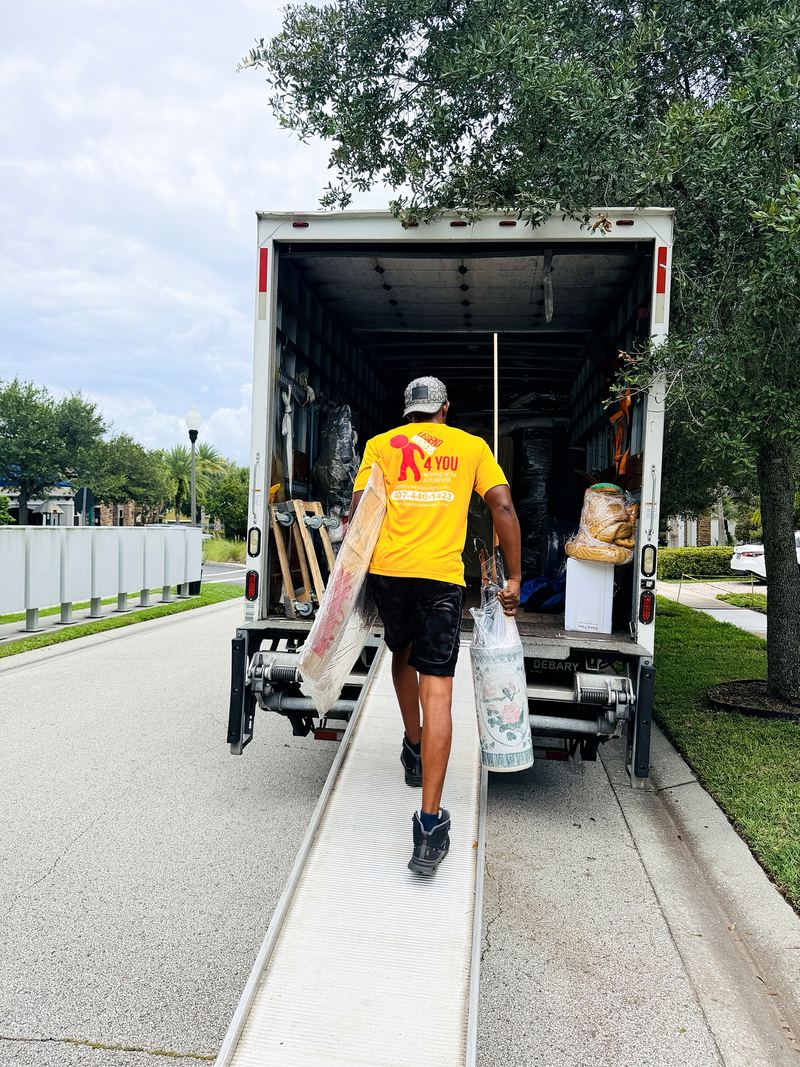 Mover walking a load up the ramp into a moving truck