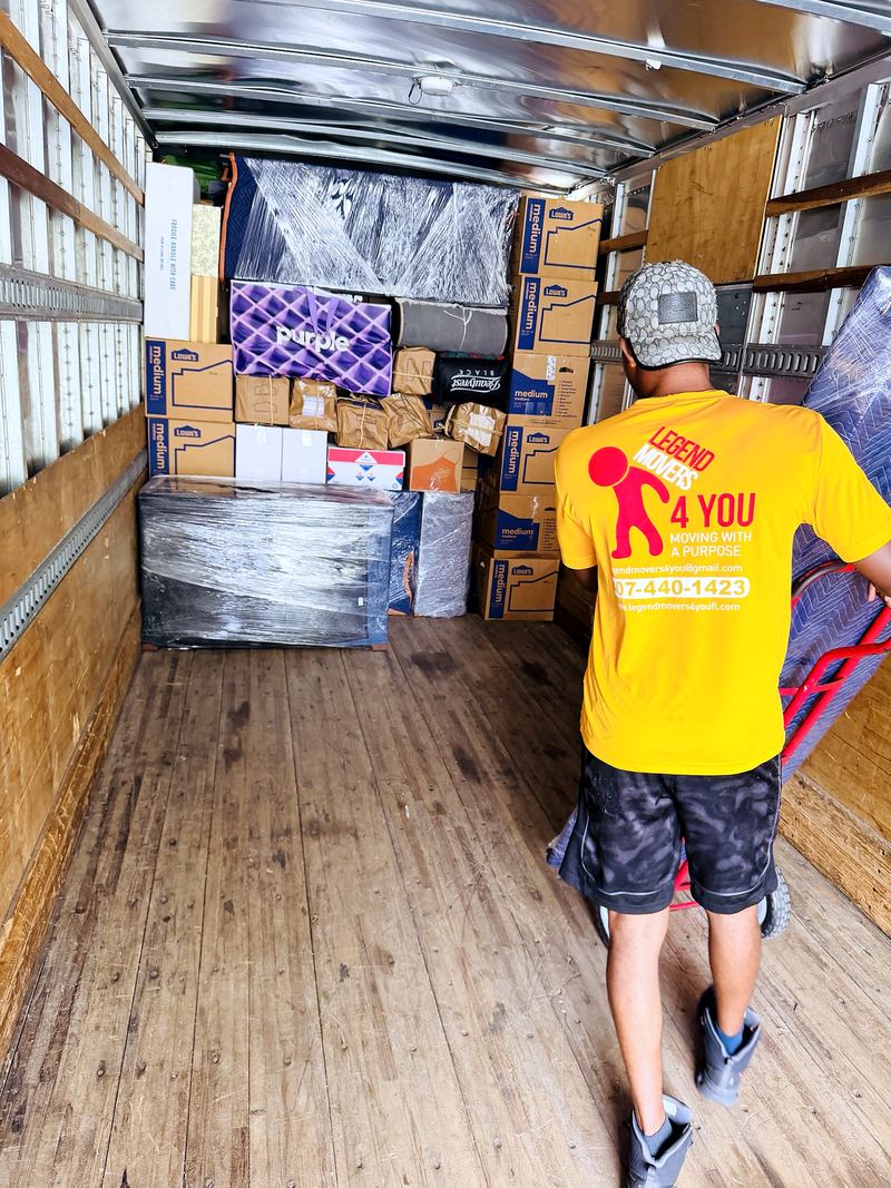 Mover standing in a tightly packed moving truck