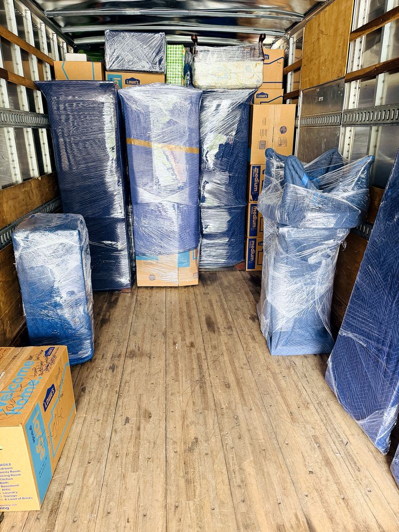 Padded and wrapped furniture loaded tight inside a Legend Movers 4 You truck