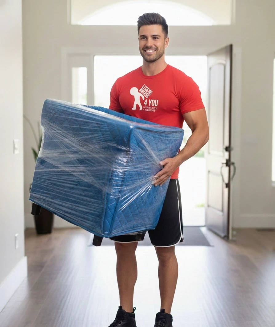 Orlando FL mover carrying wrapped furniture inside